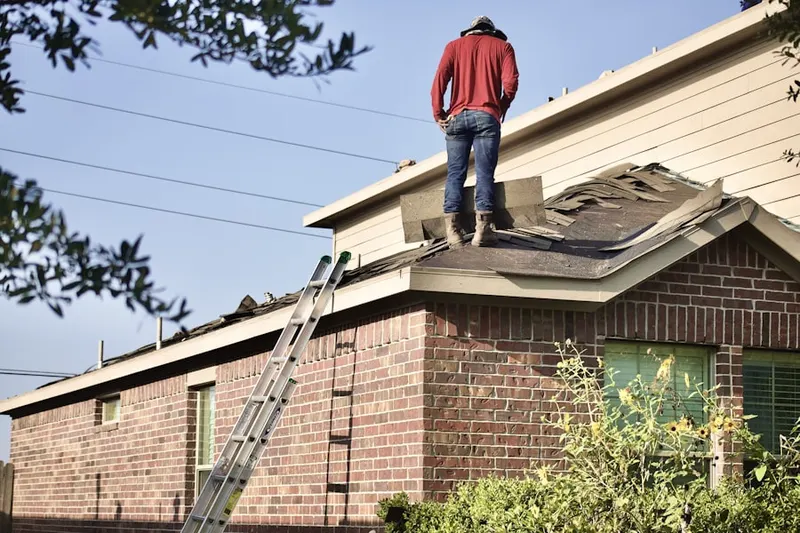 Professional roofer working on a residential roof in Oak Hall